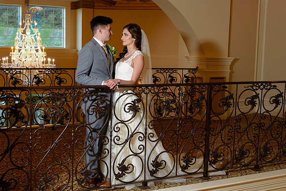 Bride groom with chandeliers at Aria Wedding Venue