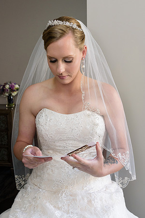 Bride opening gift and reading card at The Heritage Hotel in Southbury, Connecticut