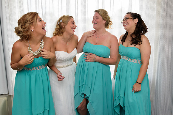 Bridesmaids and bride laughing during getting ready wedding photos
