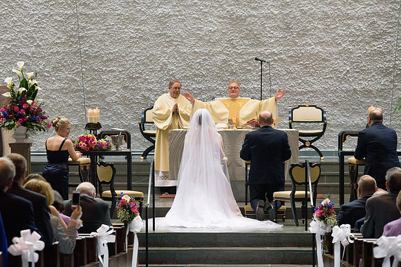Catholic wedding ceremony, groom and bride kneeling at the alter