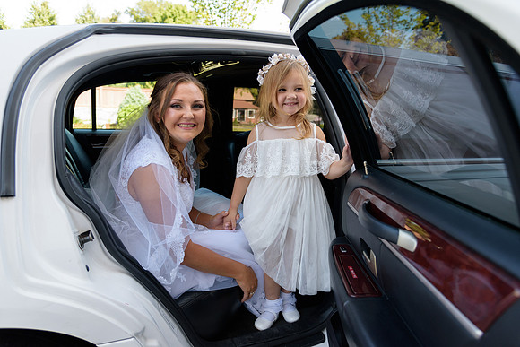Bride and her daughter exit limo for wedding ceremony at St. Rose of Lima Church Newtown Connecticut