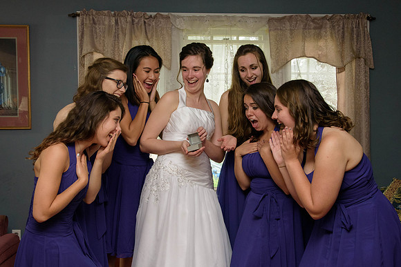 Bride shows ring to bridesmaids, private residence.