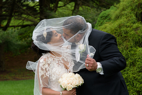 Bride and Groom kiss under the veil at Ethan Allen Hotel Wedding in Danbury, Connecticut