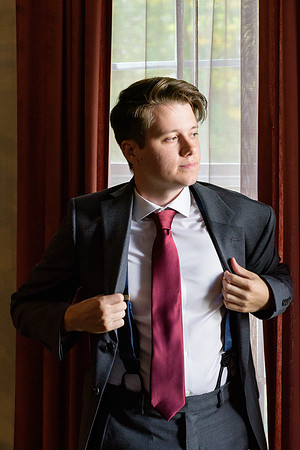 Groomsmen putting on suit getting ready shots home in Torrington, Connecticut window lighting