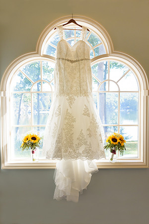 Wedding dress hanging in window with sunflowers for wedding at The Waterview in Monroe, Connecticut