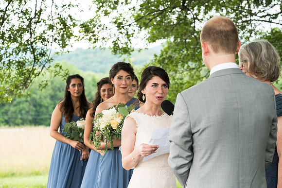 Bride reading vows, wedding ceremony, Red Barns at Hampshire, College, Amherst Mass.