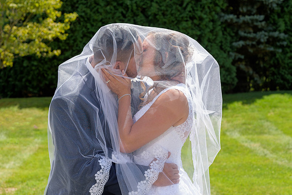 Bride and groom kissing under the veil at the Waterview Wedding in Monroe Connecticut