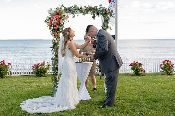 Groom kissing his bride at The Water's Edge Wedding Ceremony in Westbrook, Connecticut