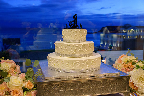 Sunset over beach wedding cake at The Water's Edge in Westport Connecticut