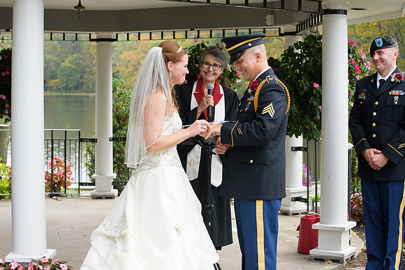 Bride and groom exchanging rings at their Military Wedding at Mill on the River in South Windsor Connecticut