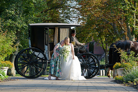 Bride and her mom arriving by horse and carriage to the wedding ceremony at Saint Clements Castle in Portland Connecticut.