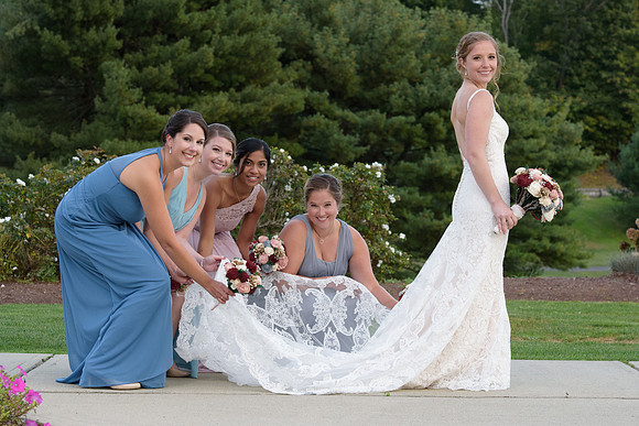 bride and bridesmaid taking portraits at The Traditions Golf Club Wedding in Wallingford Connecticut