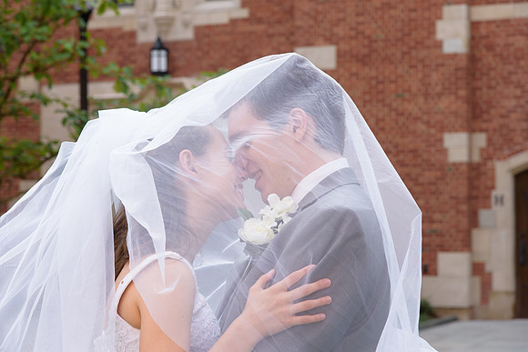 Bride and Groom kiss under veil at Yale College Wedding