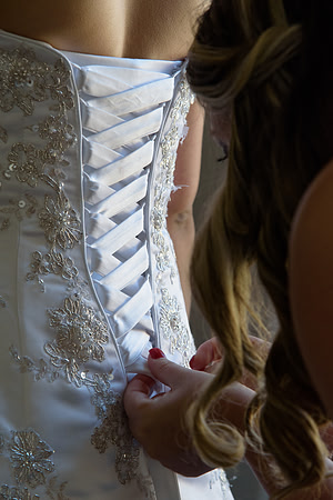 Bridesmaid lacing up dress, getting ready photos Latino wedding, Connecticut Wedding Photogrpaher