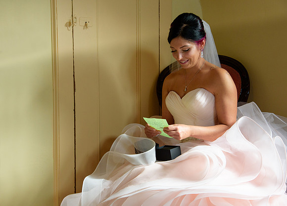 Bride opening her gift photo for her getting ready shots at St. Clements Castle wedding photographer in Portland Connecticut