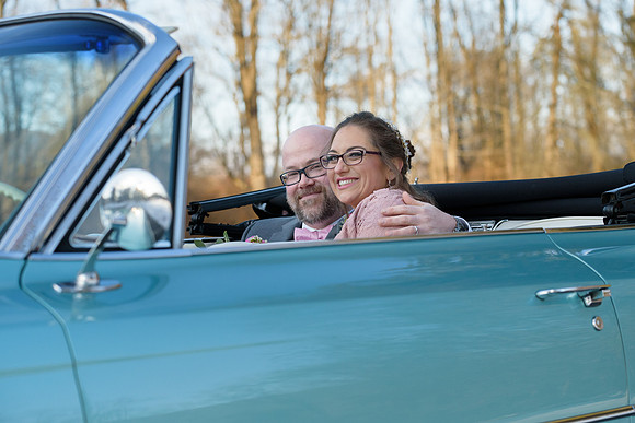 Bride and groom in blue Cadillac convertible New Milford, Connecticut
